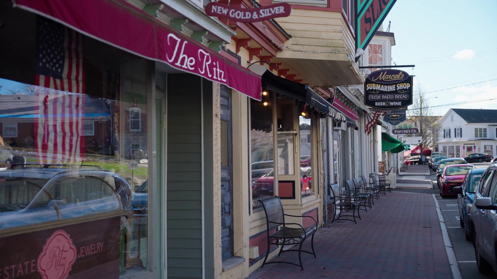 Shops along a street in Boothbay Harbor, Maine, with no one on the sidewalk
