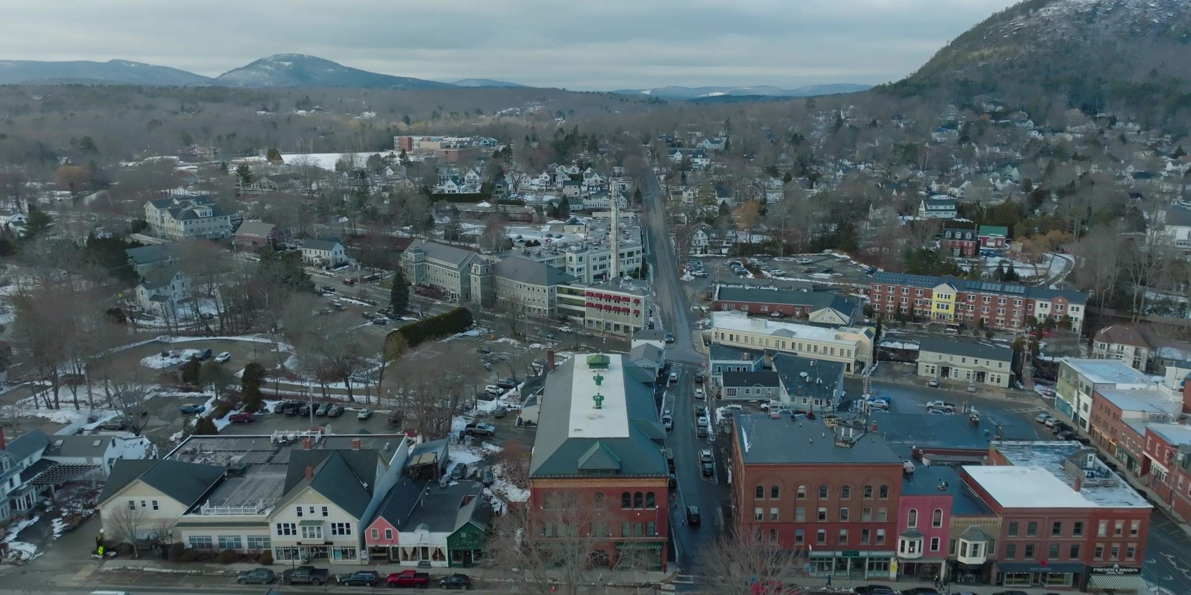 Aerial view of downtown Camden, Maine, with Mount Battie rising behind the town