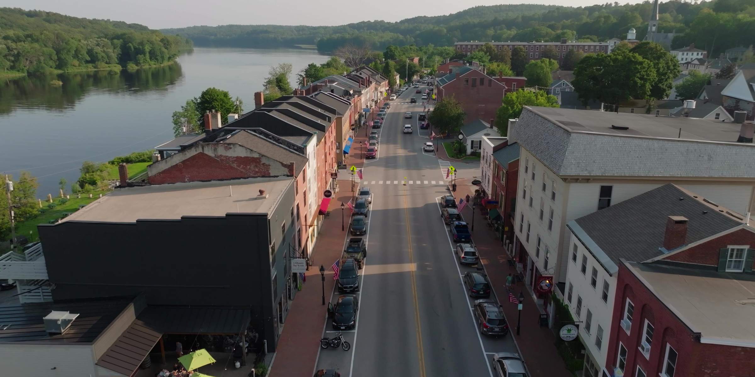 Aerial view of Water Street in Hallowell, Maine, running down to the Kennebec River in summer
