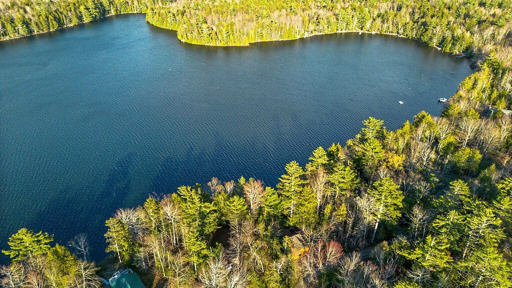 Aerial view of Halfmoon Pond in Searsport, Maine, with forested shoreline